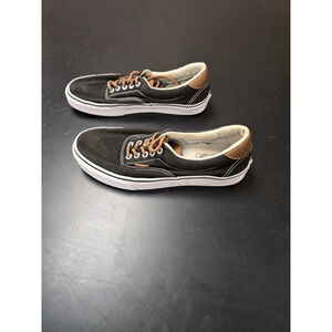 Vans Era 59 sneakers with a black canvas upper and brown leather accents.